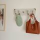 Wall-mounted coat rack 50 cm – 4 hooks and decorative central button