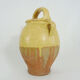 Old jug, chevrette, water pitcher in glazed yellow sandstone. Early twentieth century