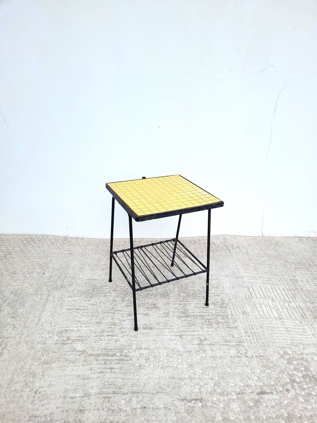 Small vintage yellow side table with magazine rack.