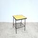 Small vintage yellow side table with magazine rack.