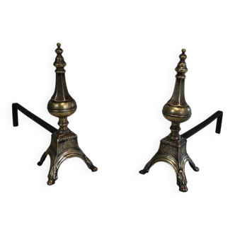 Pair of chiselled bronze and wrought iron fire dogs in the Louis XVI style.
