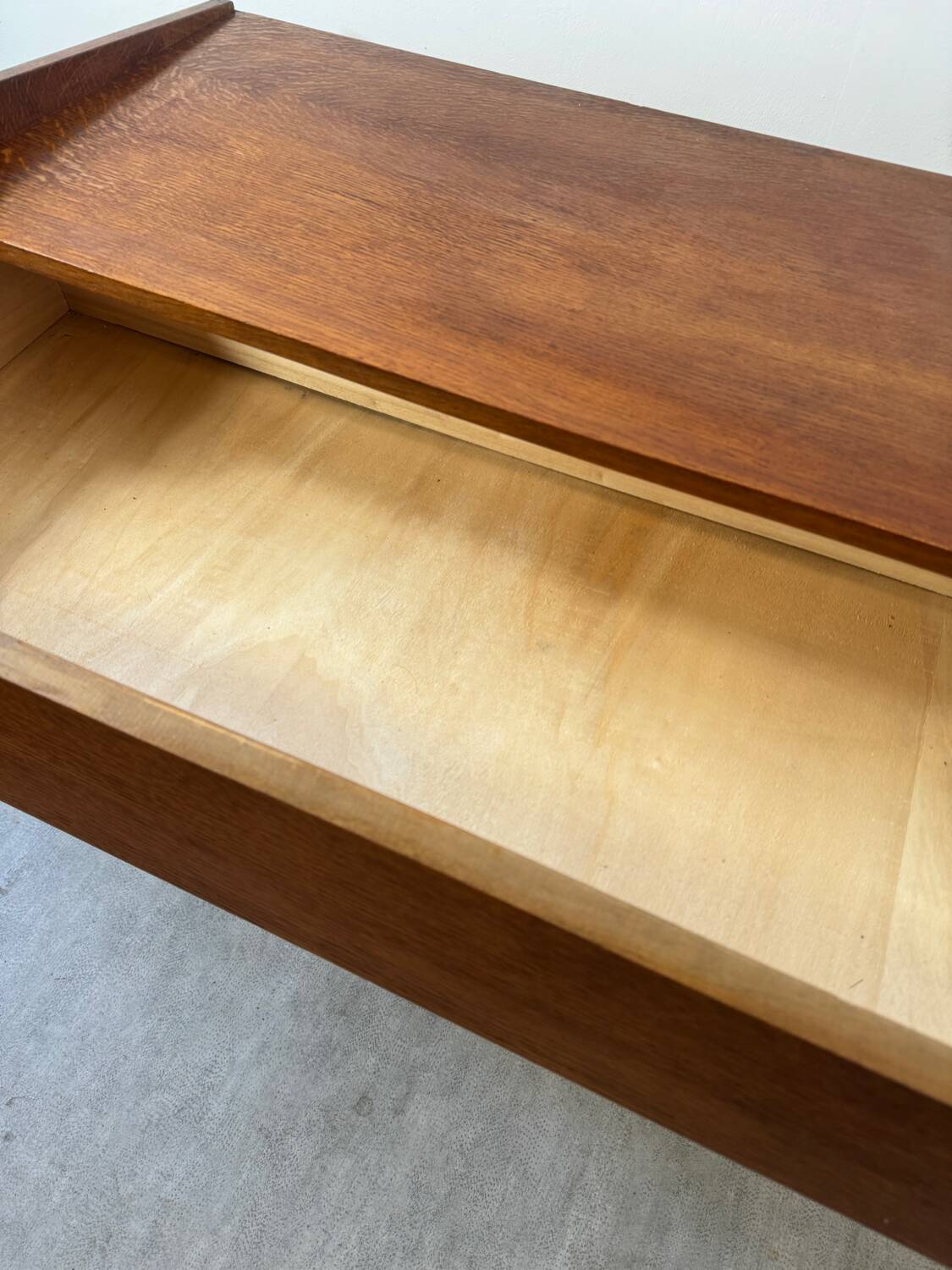 Vintage wooden chest of drawers with tapered legs.