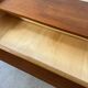 Vintage wooden chest of drawers with tapered legs.