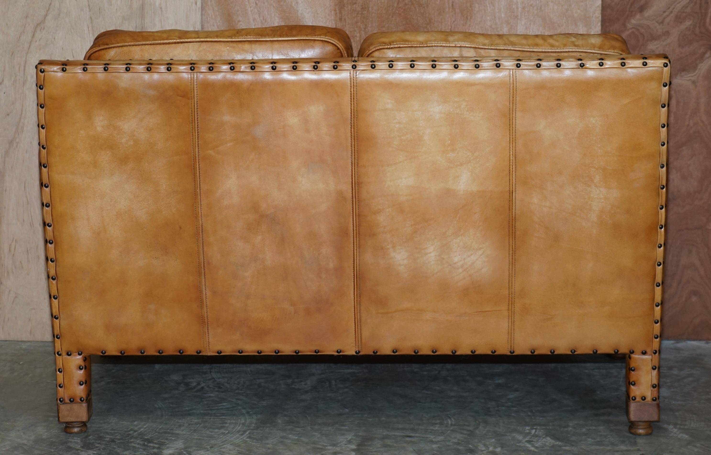 Two-seater leather canapé, hand-tanned, Edwardian style with studs.