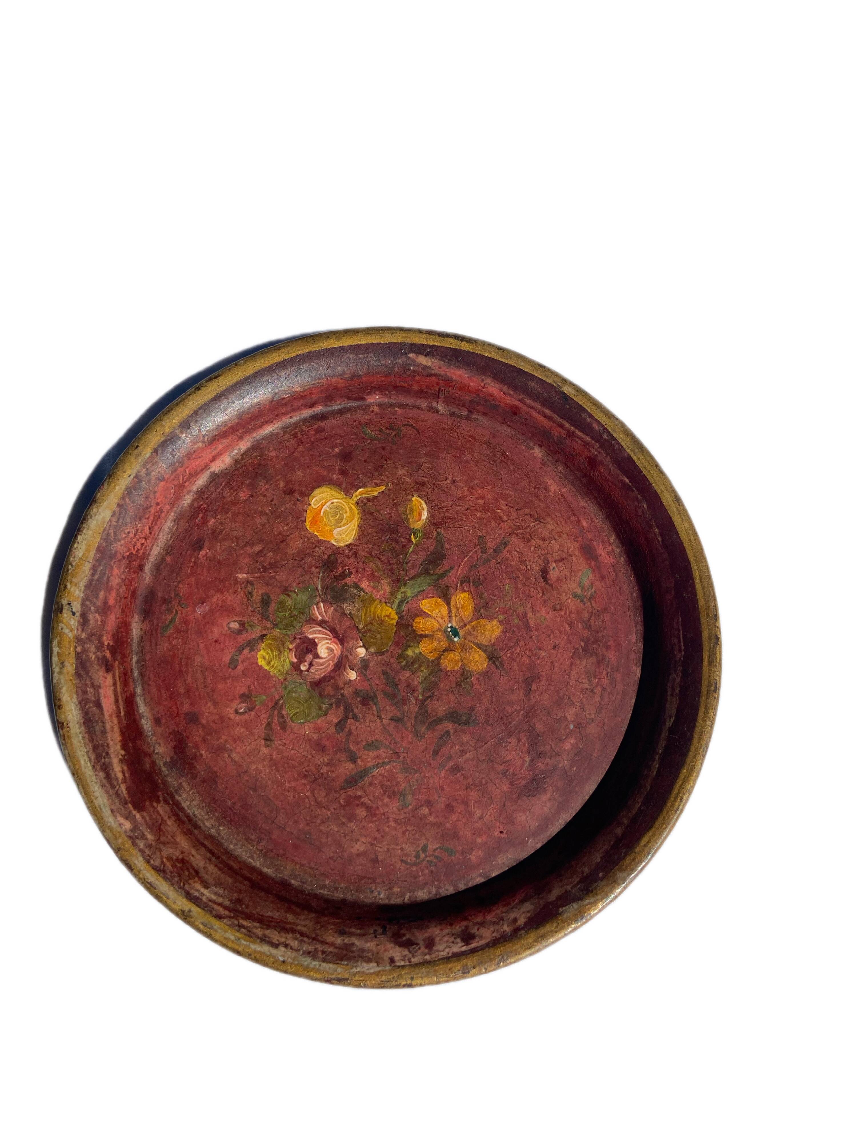 Small antique lacquered dish with hand-painted floral decoration.