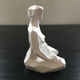 Statuette woman seated in plaster