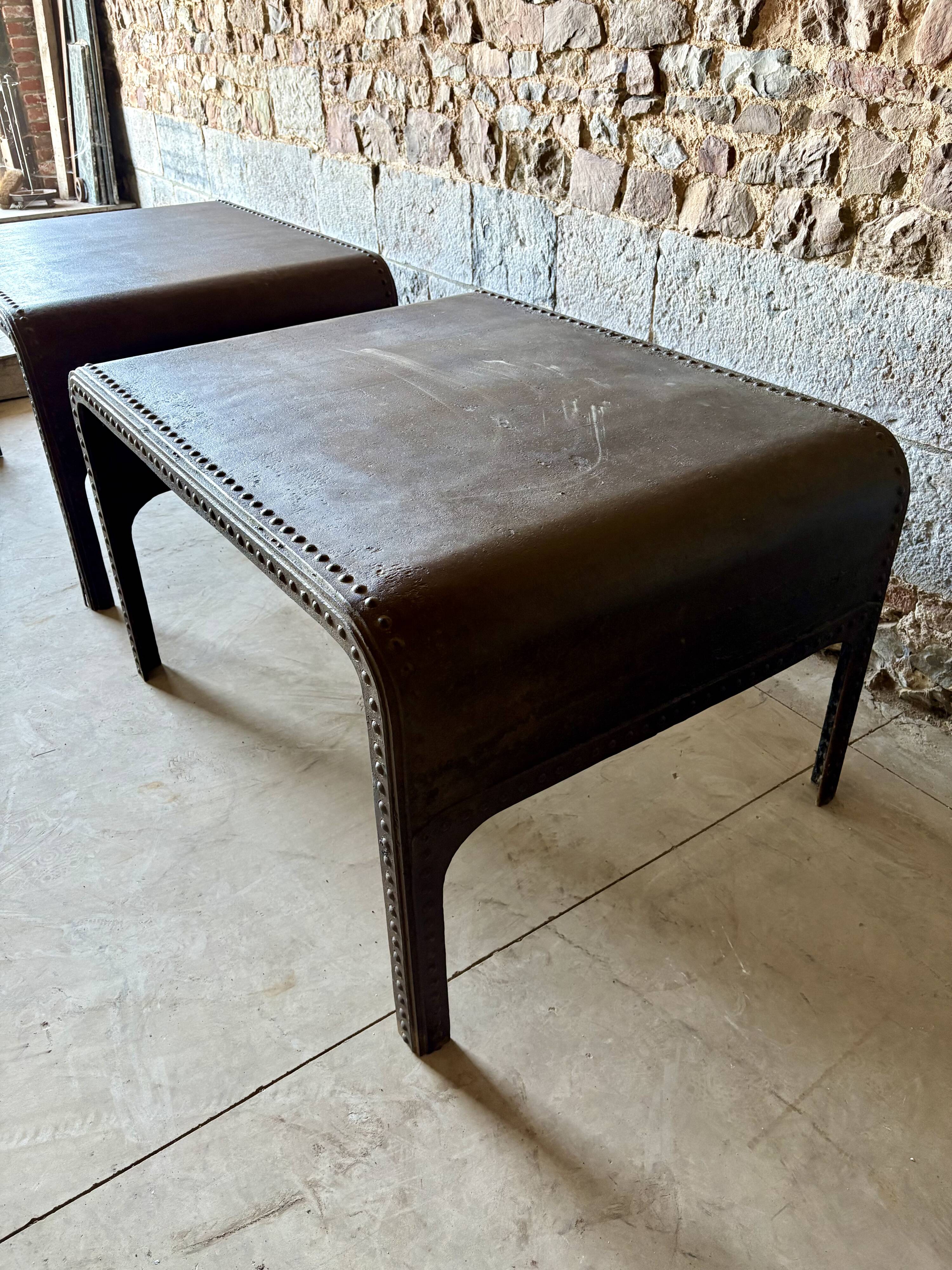 Pair of large riveted metal industrial tables