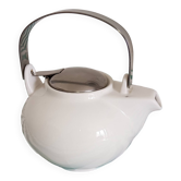 White porcelain teapot. Shiny stainless steel handle and lid