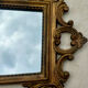 Carved and gilded wooden wall mirror.