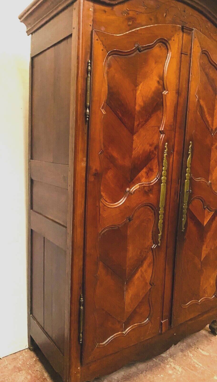 Louis XV armoire with gendarme's hat in solid cherry wood, 18th century