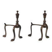 A pair of vintage brass andirons with a zoomorphic design.