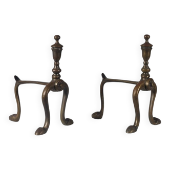 Pair of brass andirons with a vintage zoomorphic design.