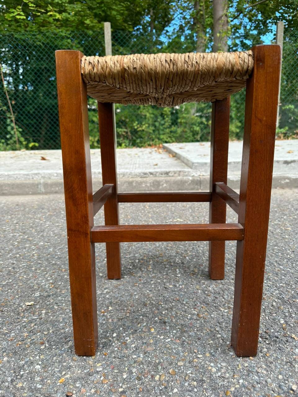 Low stool in brutalist style made of solid wood with straw, 1980.