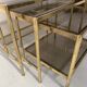 Suite de trois tables gigognes de style en laiton et verre fumé XX siècle