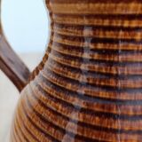 Orange glazed ceramic pitcher