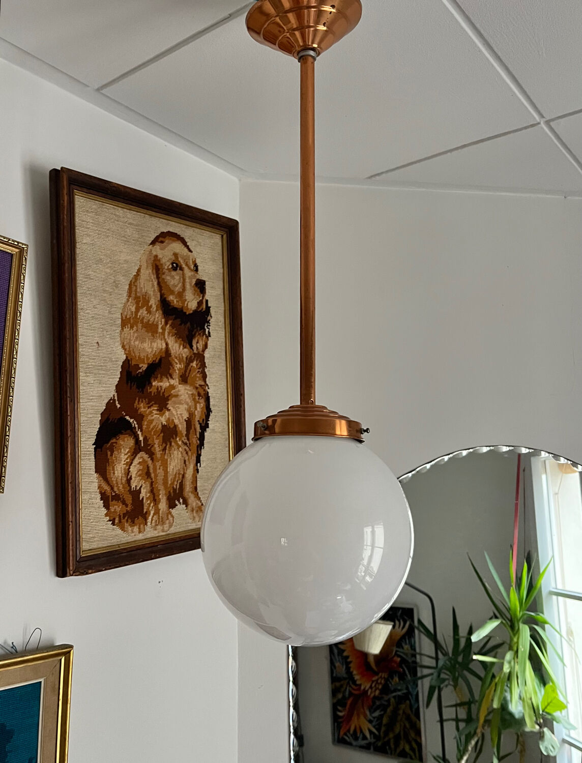 Opaline white globe pendant light with metal stem, Art Deco style.