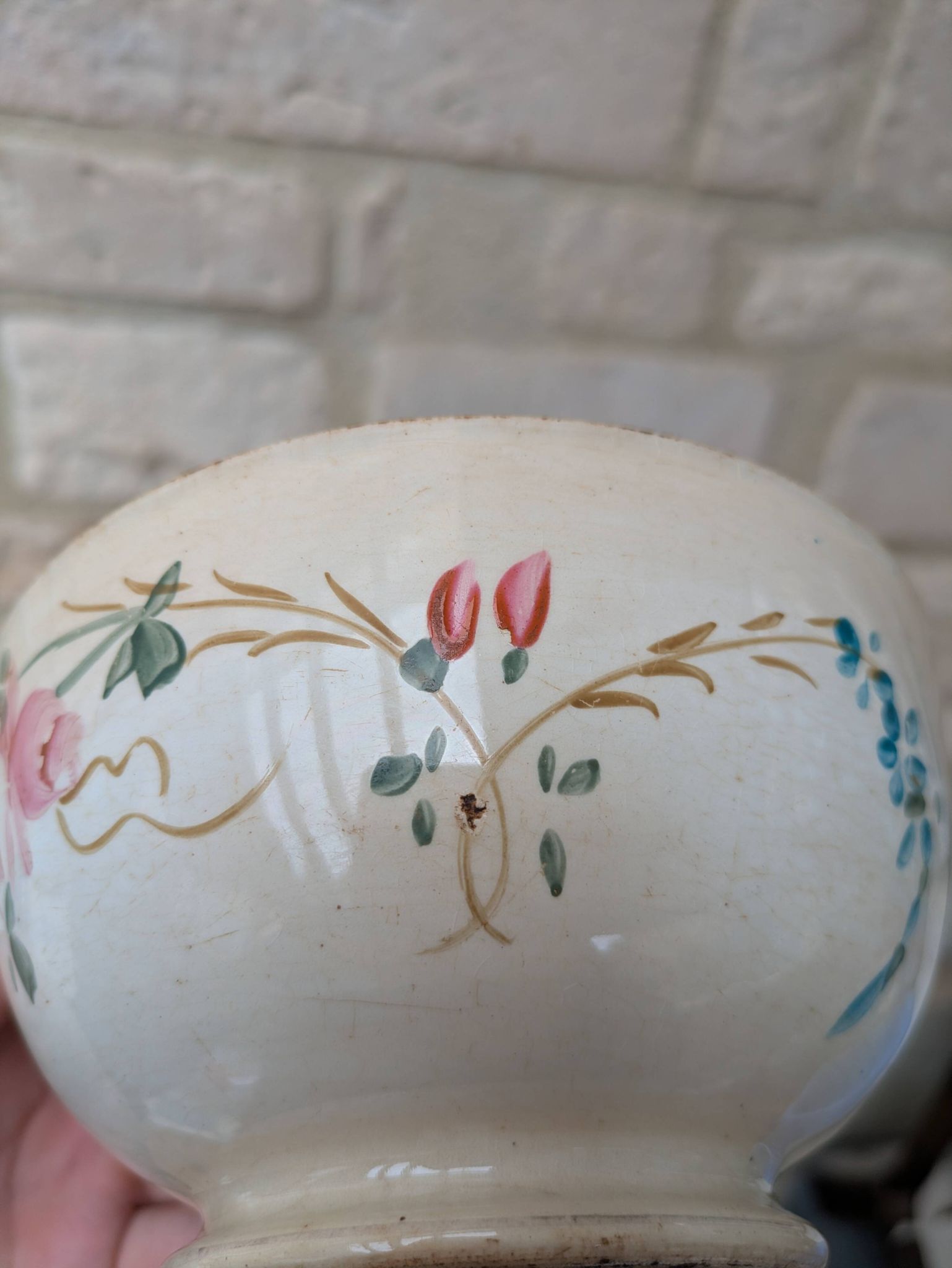 Old opaque porcelain bowl from Gien with a floral decoration.