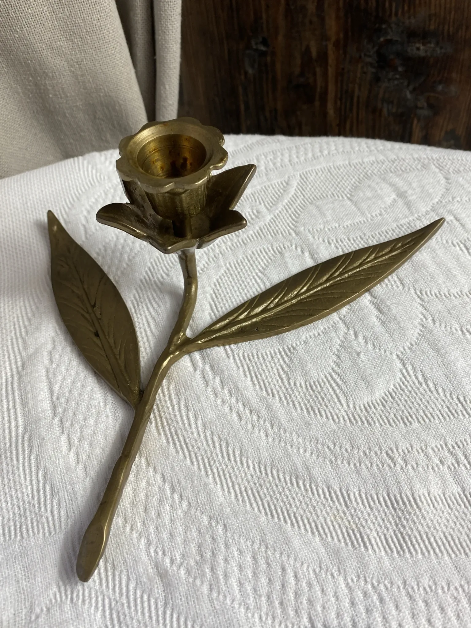 Flower candlestick and removable ashtrays in solid brass.