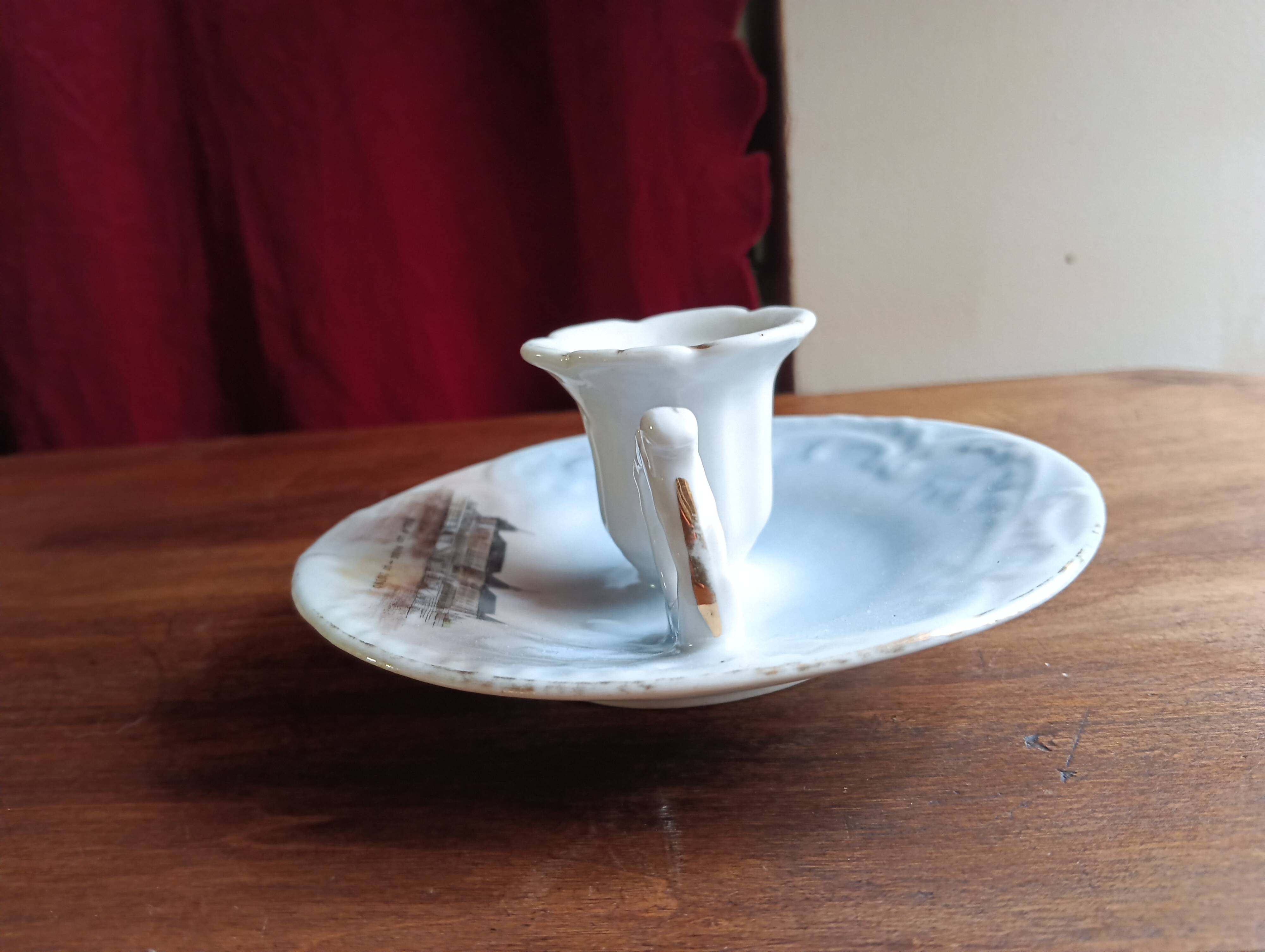 Antique handheld candle holder in porcelain