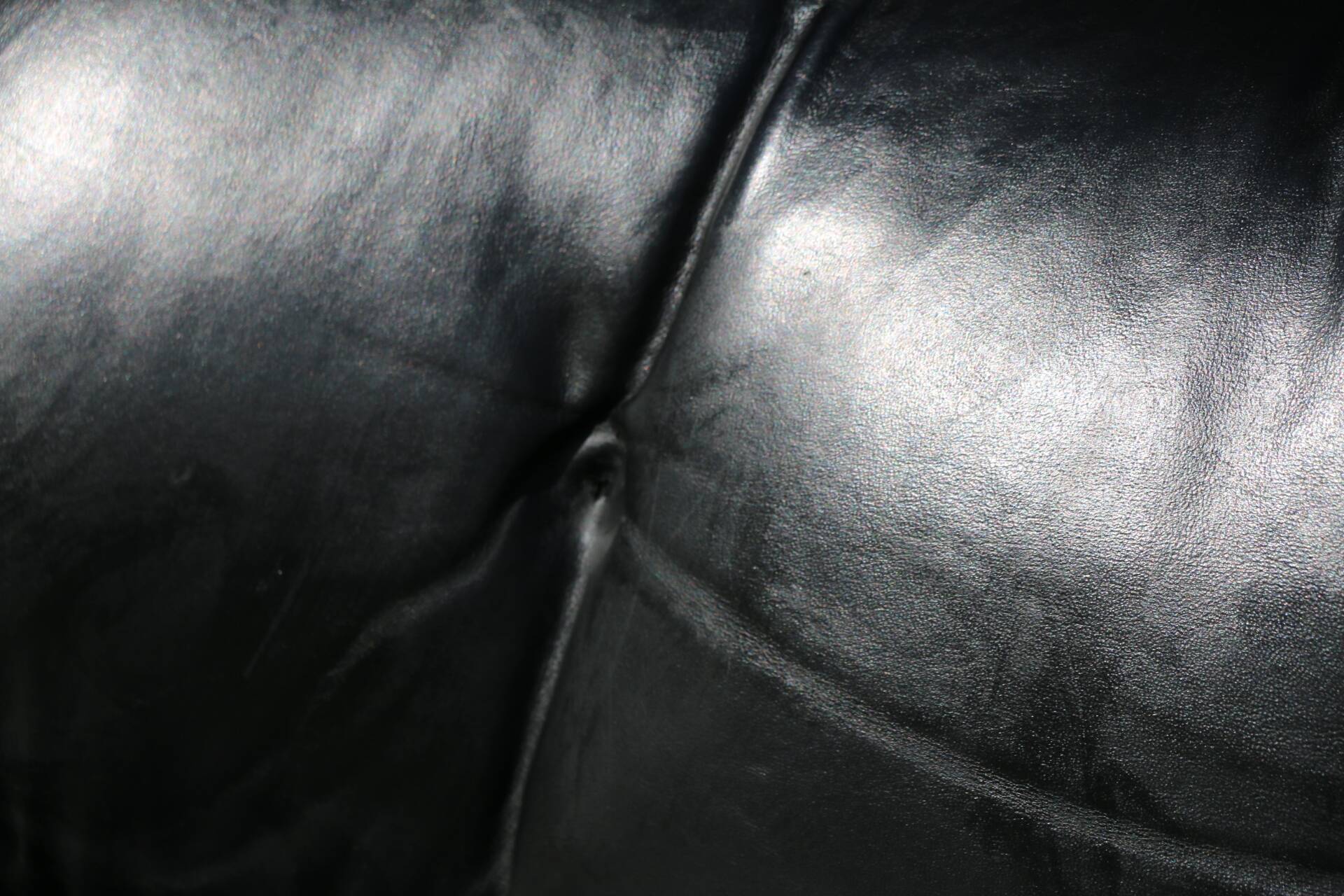 Pollock black leather reclining armchair with fixed ends