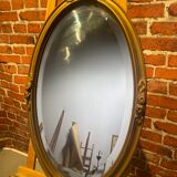 Oval mirror with wooden frame
