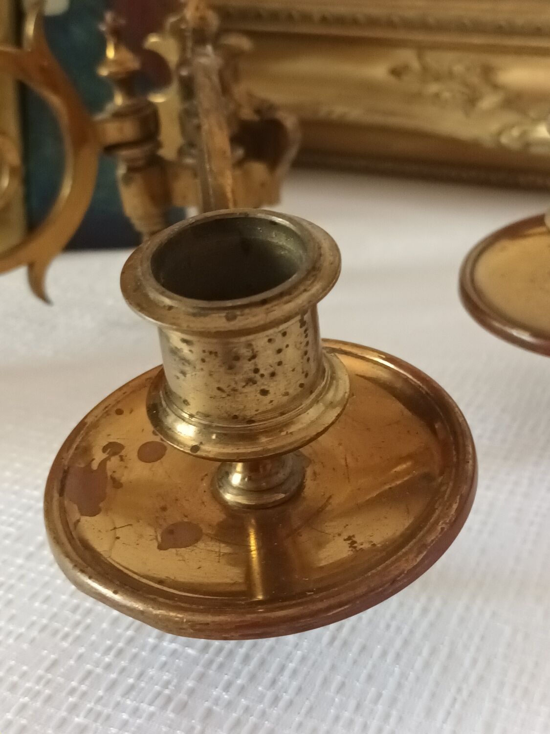 Pair of antique wall-mounted brass candle holders