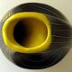 Earthenware vase decorated with yellow lines on a black and yellow background