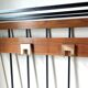 Wall-mounted coat rack in wood and black.