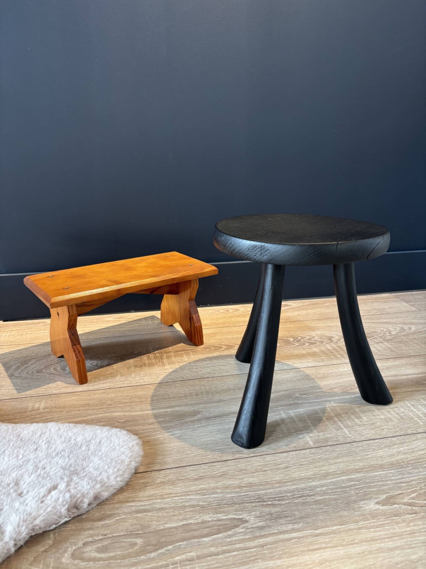 Small black wooden tripod stool