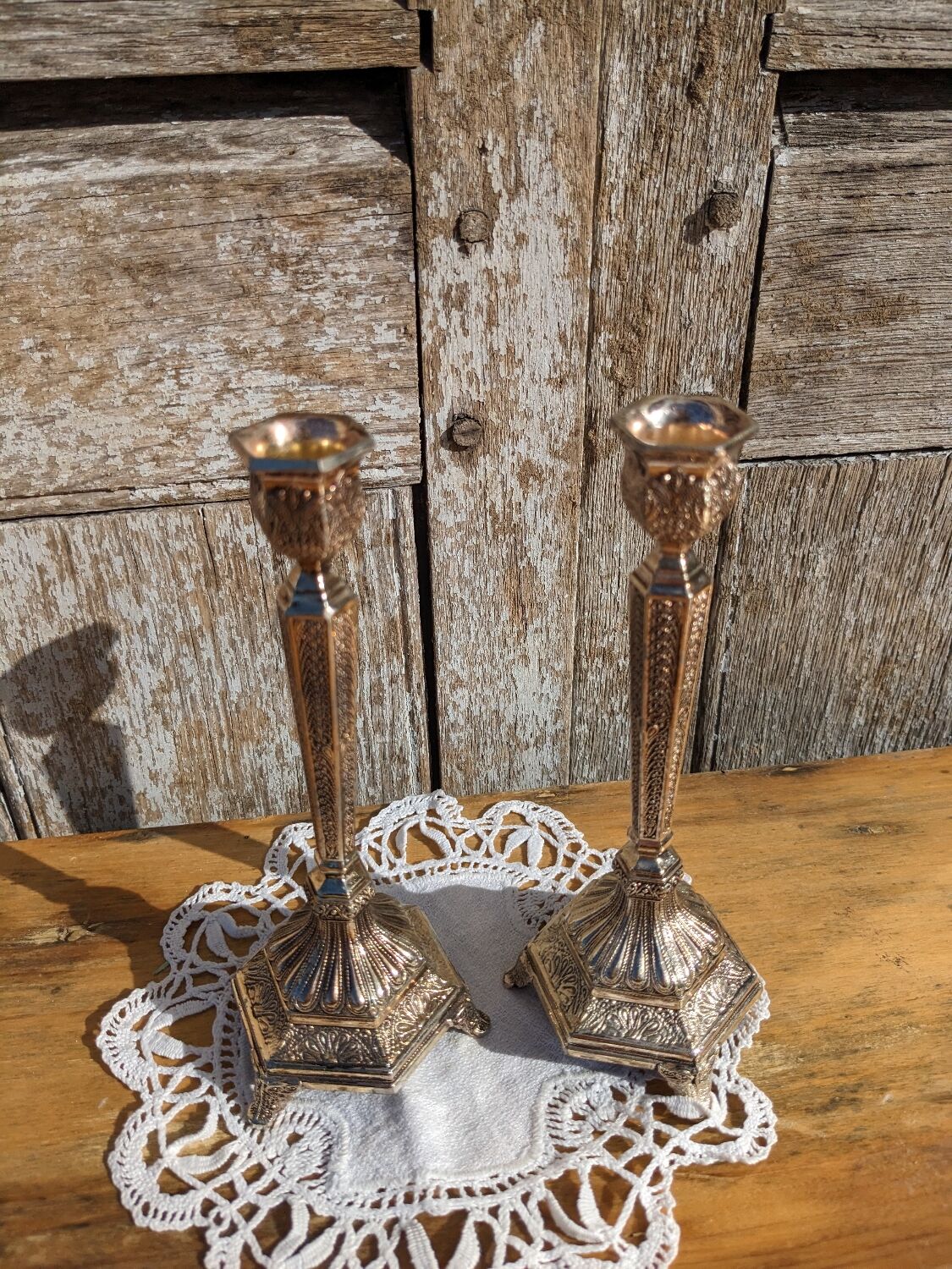Pair of chiseled metal candle holders