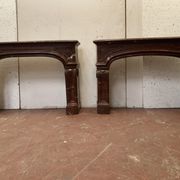 Pair of Louis XIV style fireplaces in red cherry marble. XIX century.