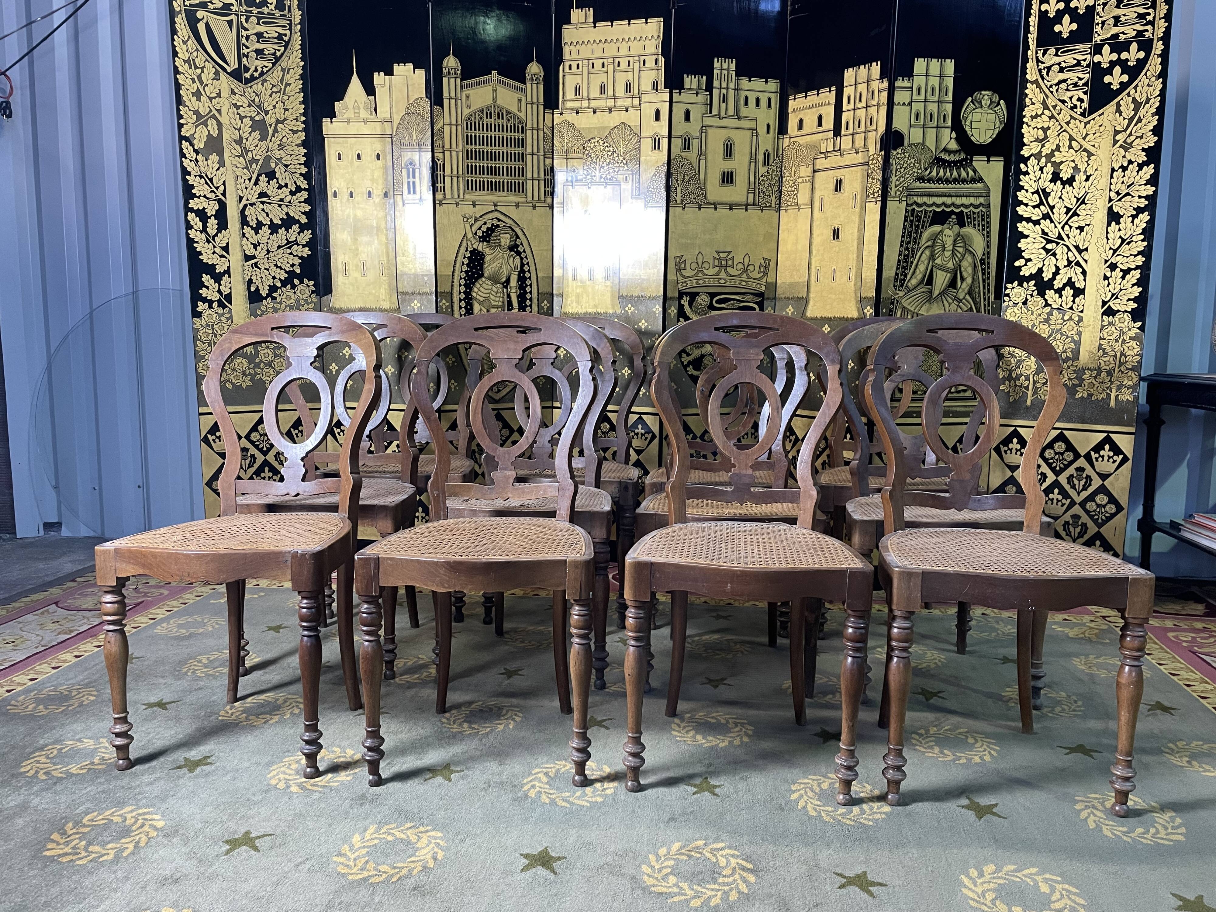 Suite of 12 Louis Philippe period chairs in walnut and canning