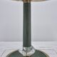 Brass table lamp with green patina and empire-style fabric shade.