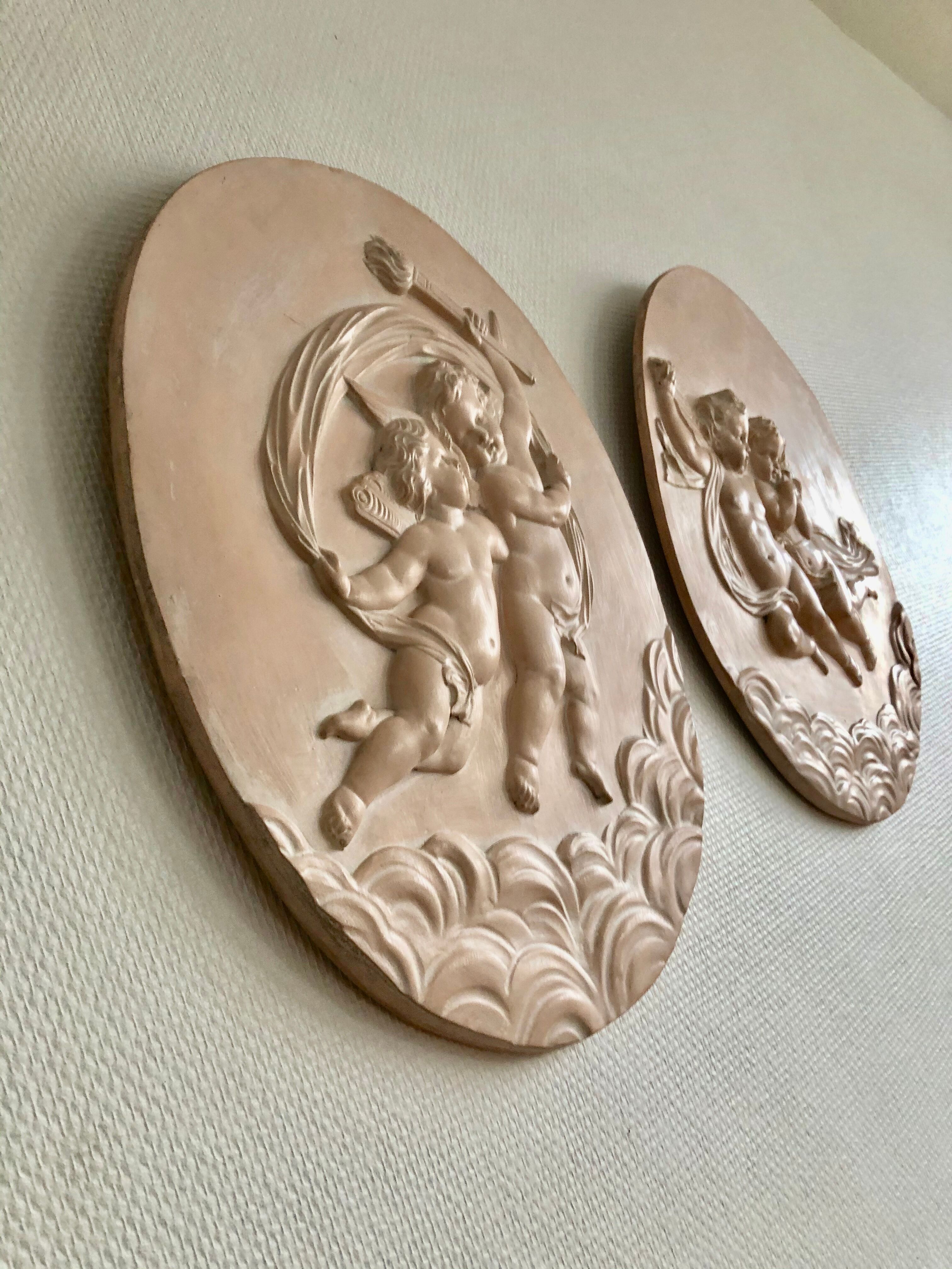 Pair of putti medallions