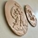 Pair of putti medallions
