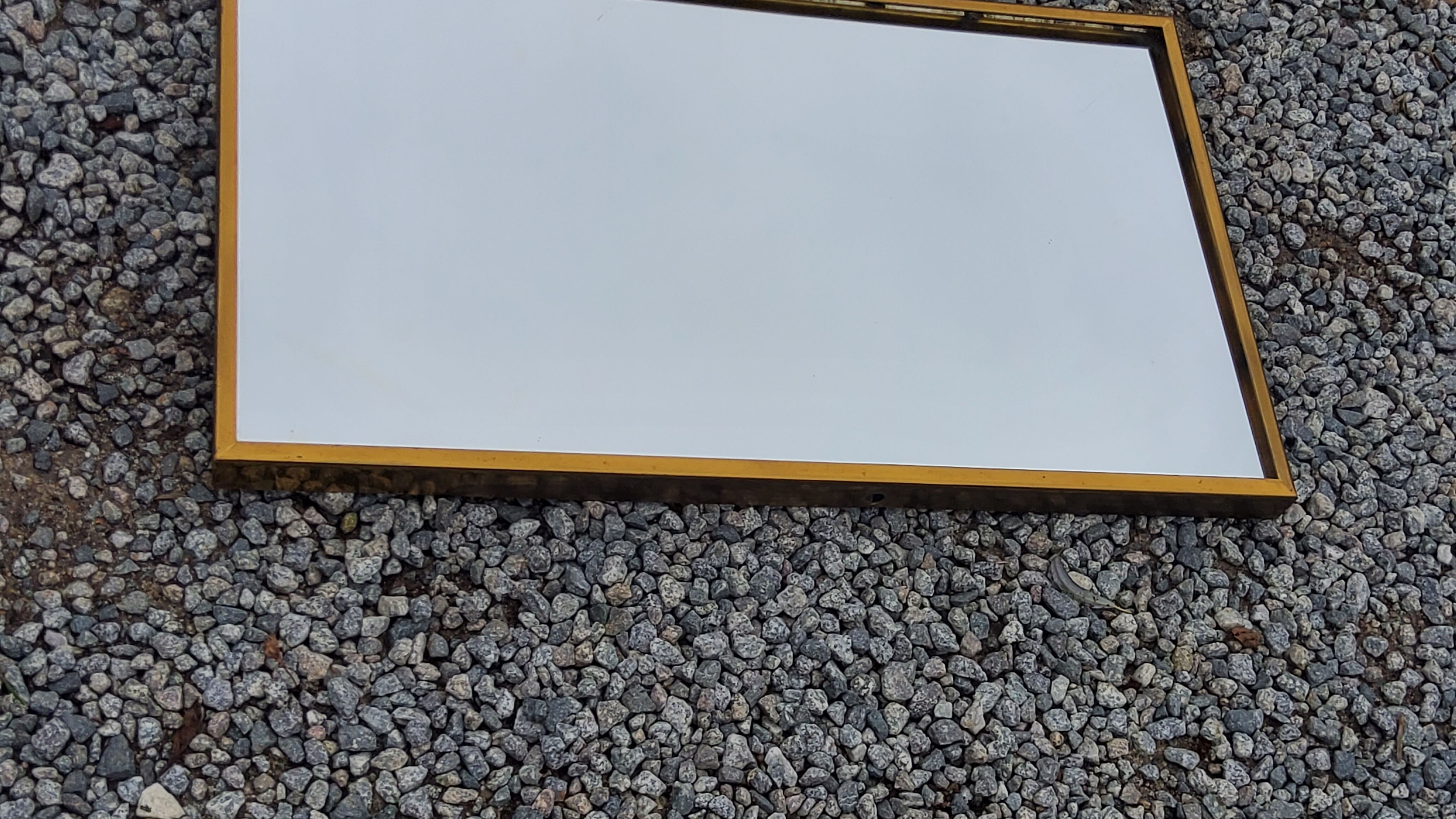 Mirror of the 70s in gilded metal, 60x35 cm