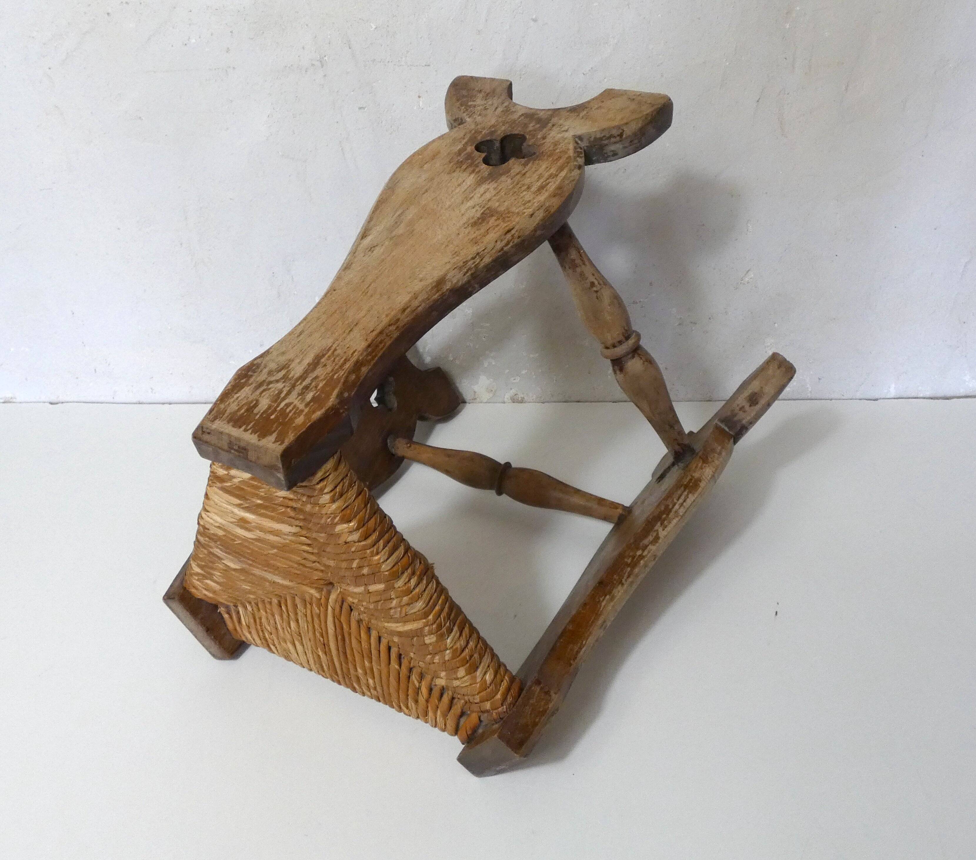 old wooden and straw tripod stool