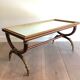 Coffee table in patinated and gilded carved wood with mirror top