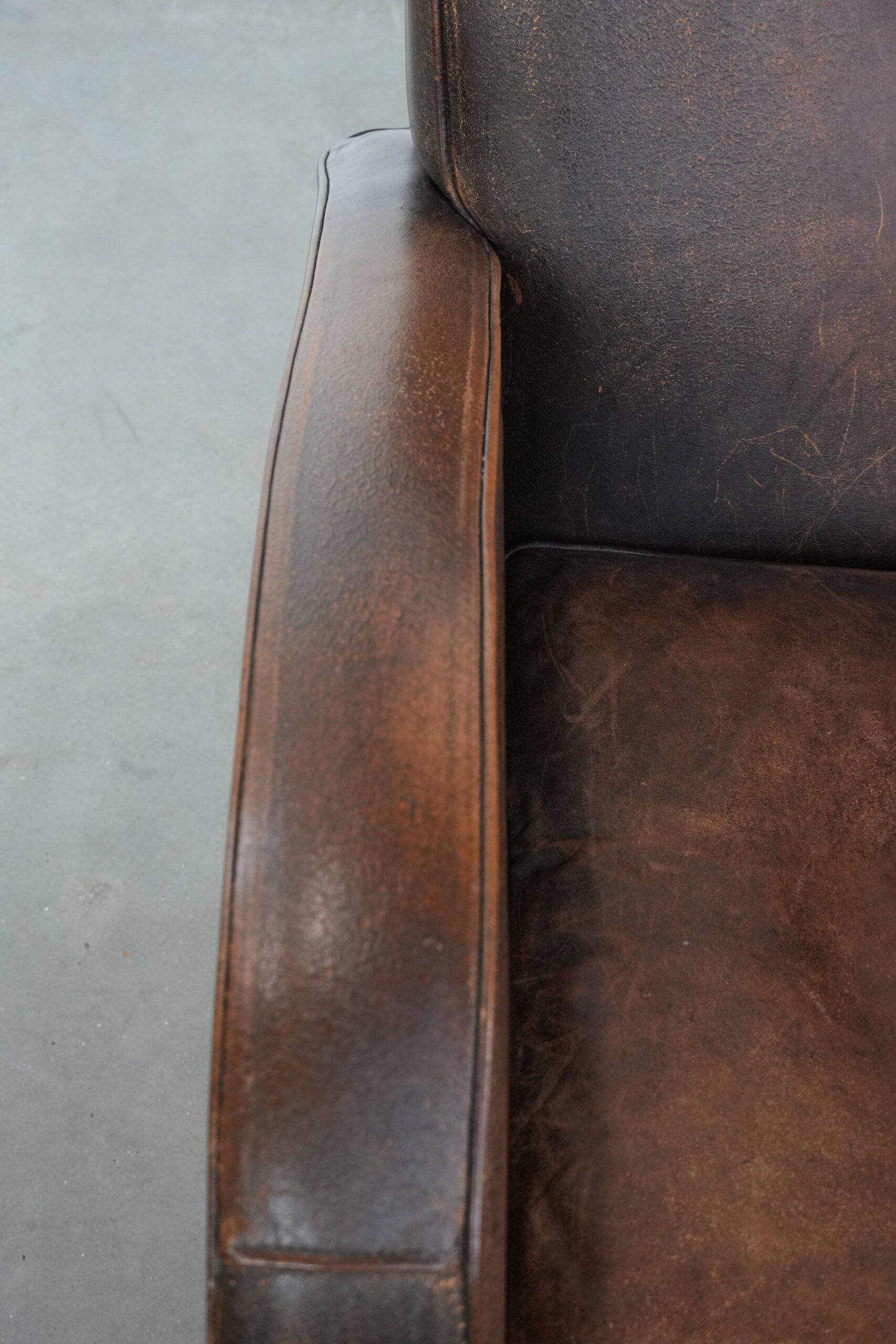 Vintage sheepskin leather design armchair in a dark cognac colour