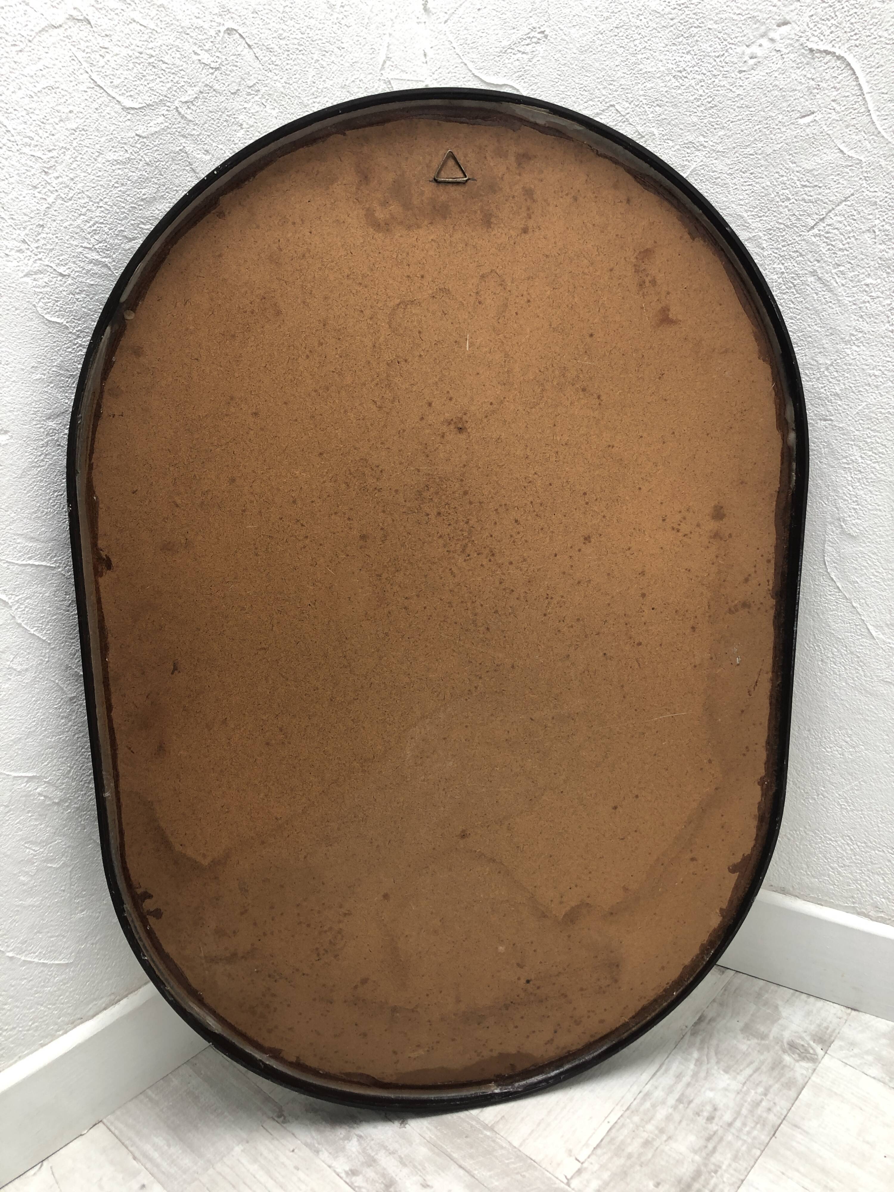 Brown plastic oval mirror, 1960s/1970s