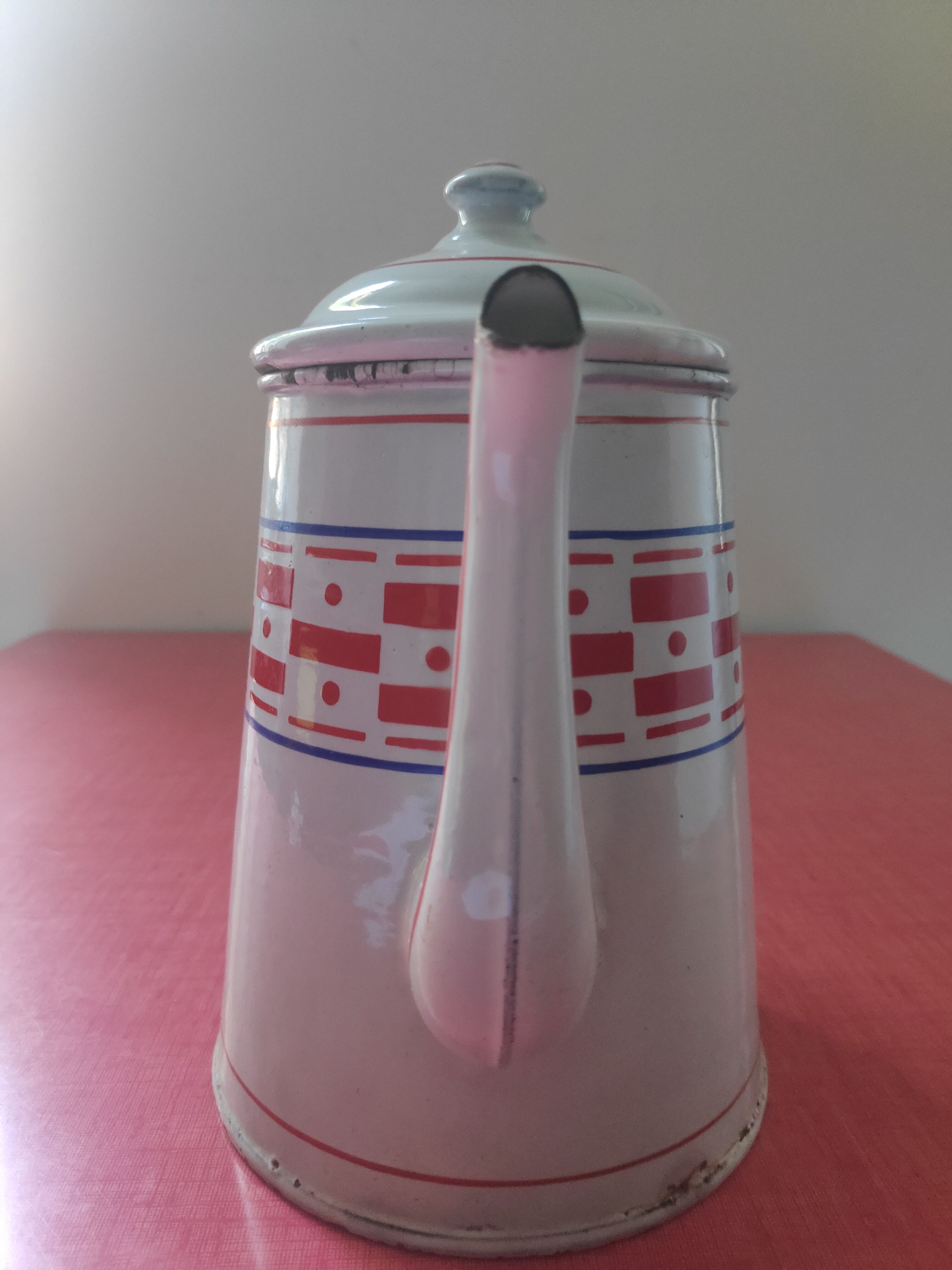 White enamelled sheet metal coffee maker with red and blue patterns