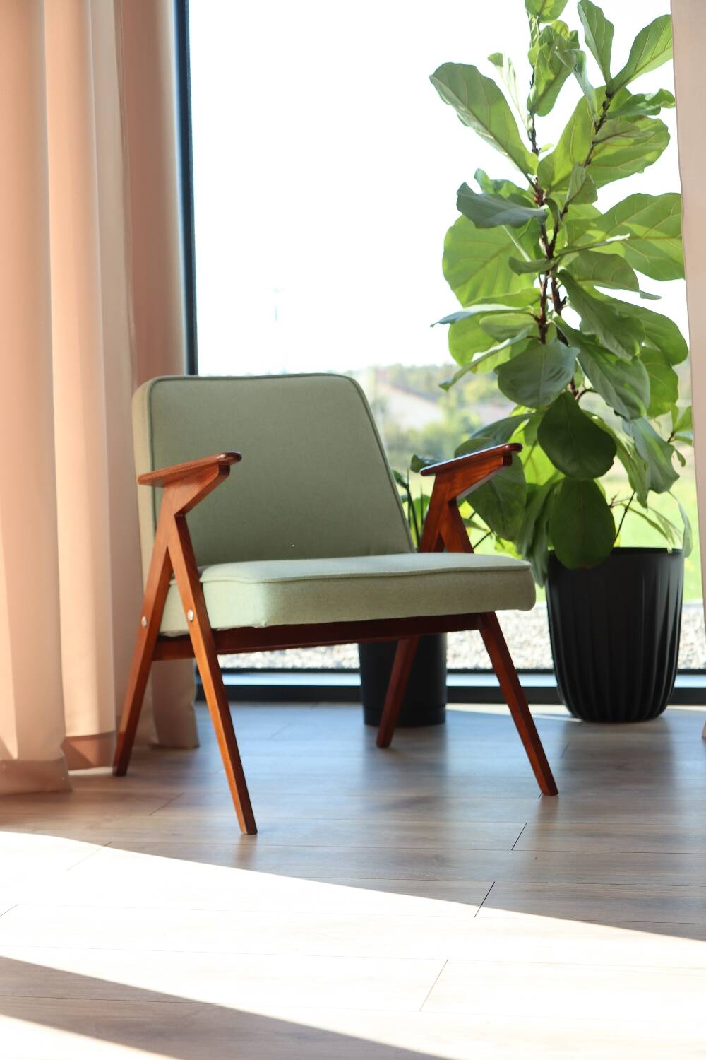 Vintage armchair in mint green wool, mid-century modern design.