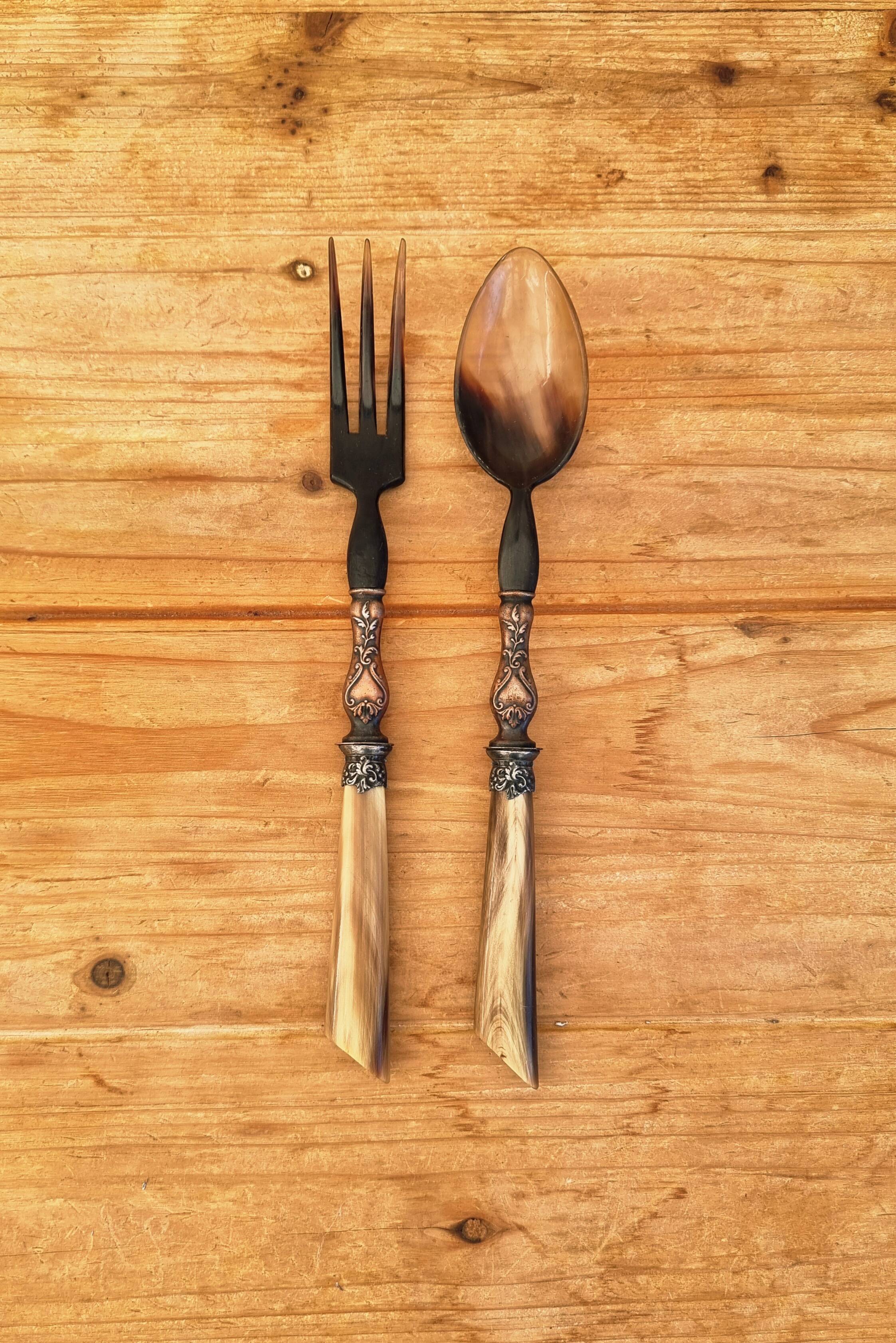 Vintage serving cutlery in horn and wrought metal
