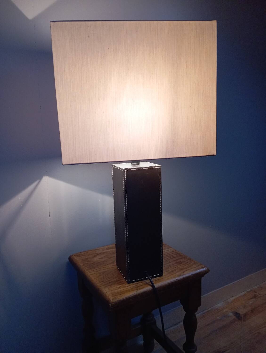 Tall cubic brown leather lamp, light gray fabric lampshade