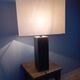 Tall cubic brown leather lamp, light gray fabric lampshade