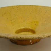 Old omelette turner, glazed yellow terracotta, south of France.