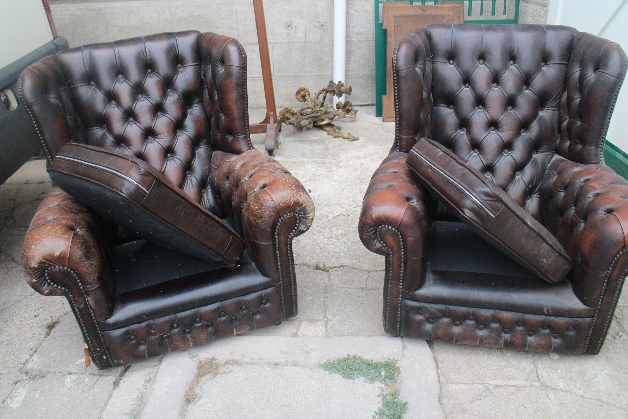 Padded chesterfield leather armchairs
