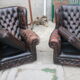 Padded chesterfield leather armchairs