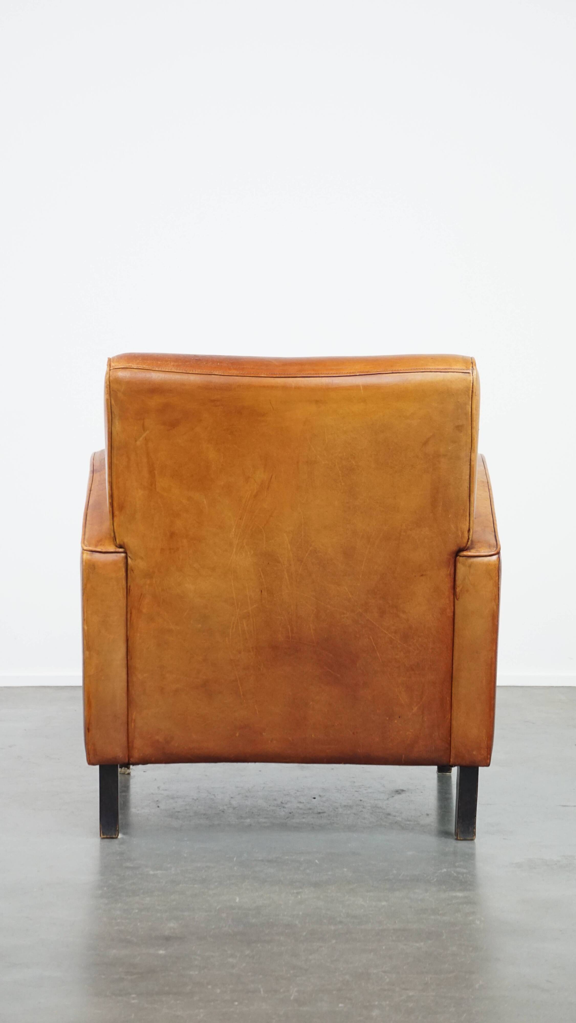 Characteristic sheepskin design armchair in beautiful warm cognac colours