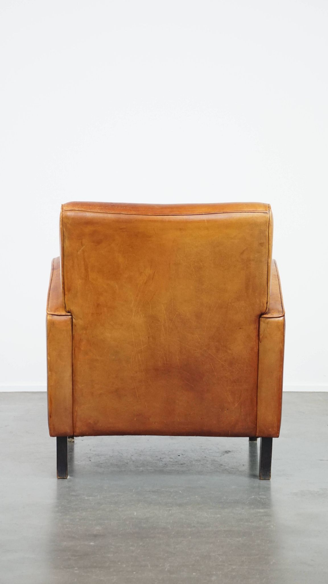 Characteristic sheepskin design armchair in beautiful warm cognac colours